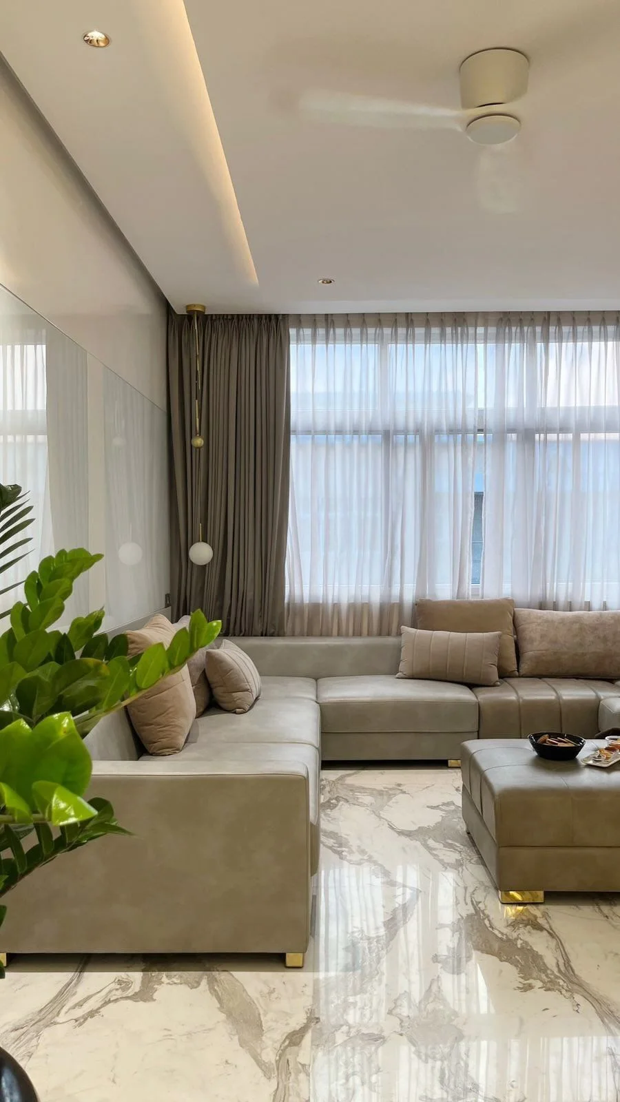 Living room with full-height glazing and marble flooring