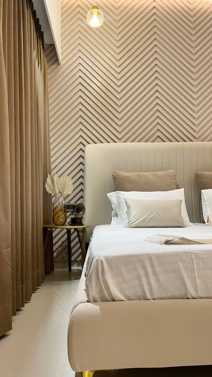 Bedroom with chevron-panelled headboard wall