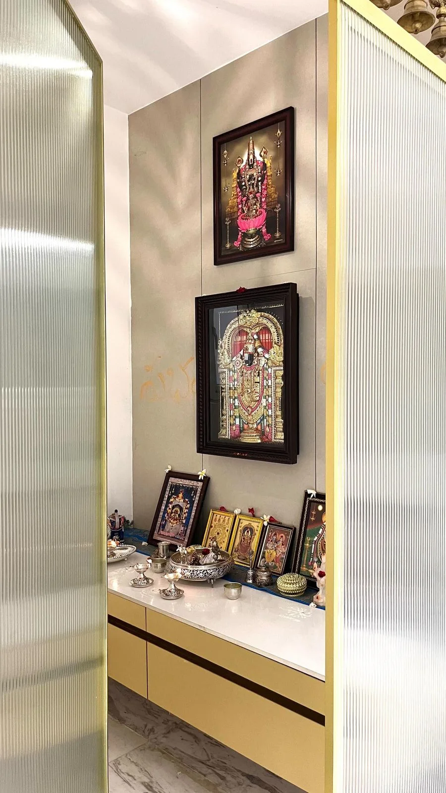 Pooja unit with fluted panelling and brass detail