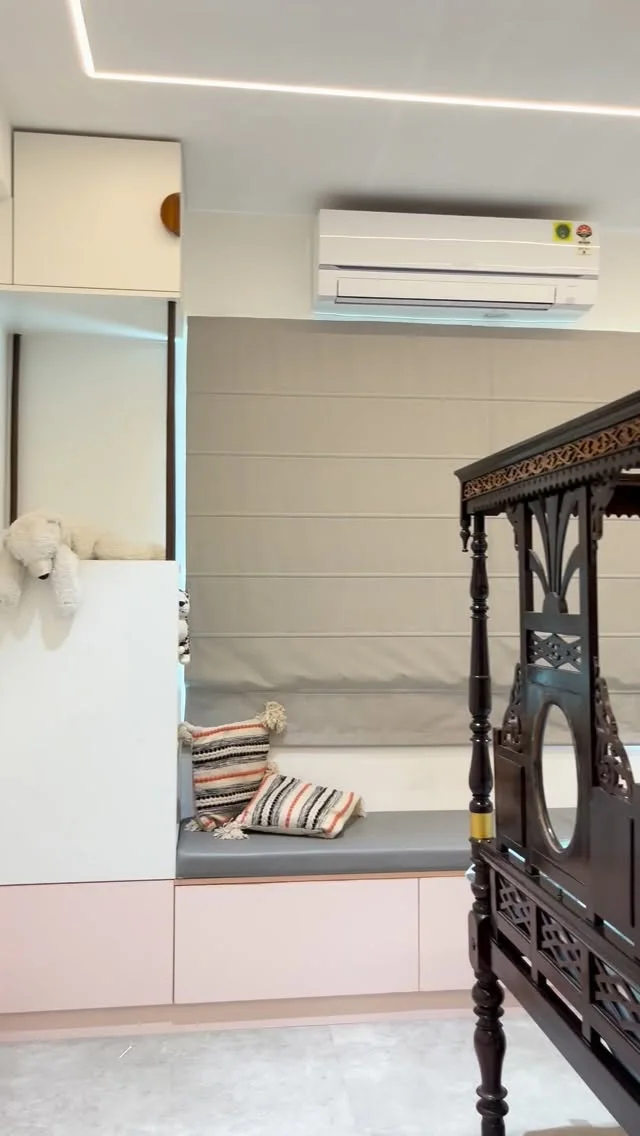 An'teak Villa, Hyderabad — bedroom with a window seat over pale-pink built-in storage