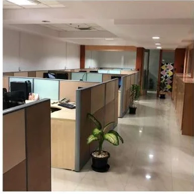KG360 office fit-out Chennai by AlcorOne Solutions — cubicle cluster along corridor with planter