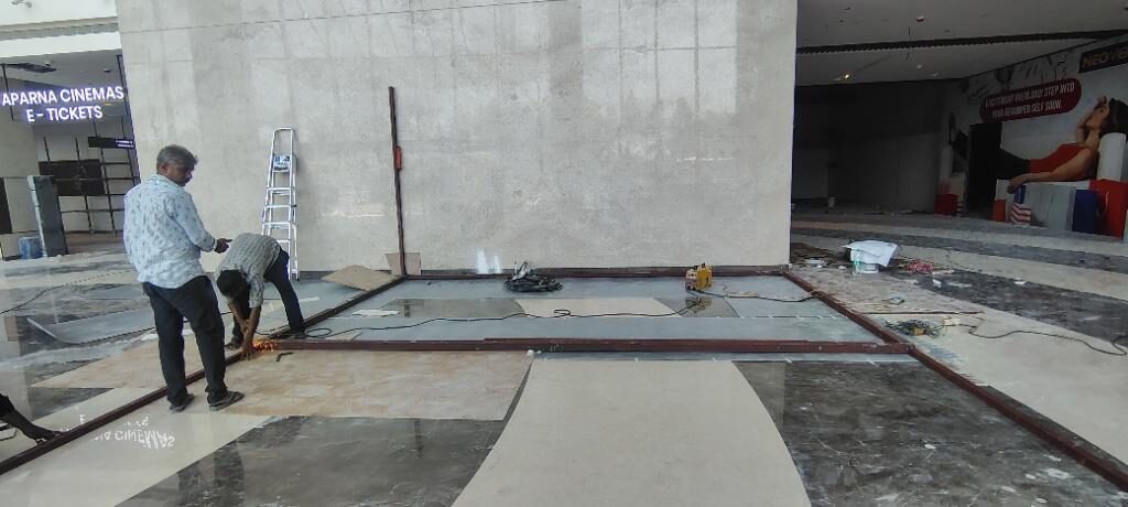 Site team setting out the kiosk footprint on the mall concourse