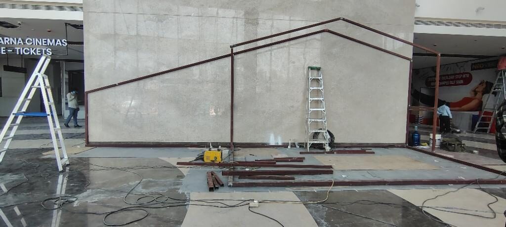 Kiosk frame viewed across the concourse with access ladder