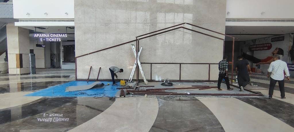 Protective sheeting laid over the mall floor beneath the frame