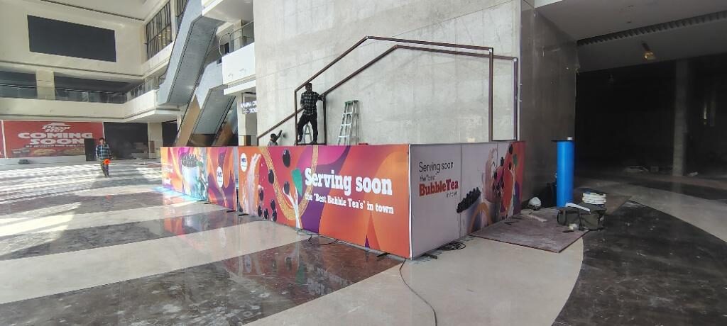 Kiosk frame and hoarding with the mall atrium behind